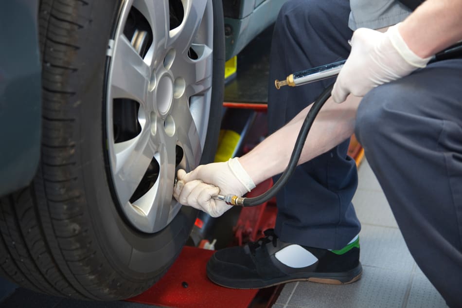 Mechanic checking tire pressure